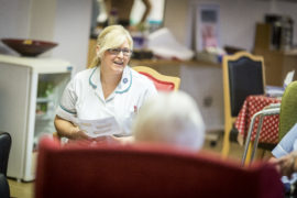 A nurse talking to day care patients