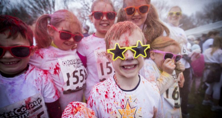 Young boy, with friends from Heyes Lane School , Timperley taking part in the ObstaColour Run