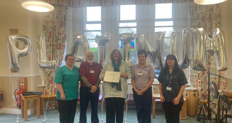 Unveiling We invest in people Platinum award plaque from Investors in People at Heald Green hospice